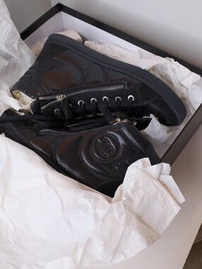 CHANEL Black Leather High-Top Sneakers with Quilted CC Detail